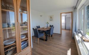 a dining room with a table and blue chairs at Scheidegg unterm Kreuzberg in Scheidegg