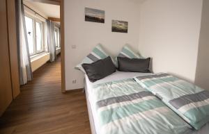 a bedroom with a bed with two pillows on it at Scheidegg unterm Kreuzberg in Scheidegg