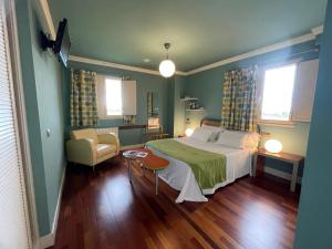 ein Schlafzimmer mit einem Bett und einem Stuhl in der Unterkunft Hotel Mi Norte in Ribadeo