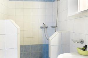 a bathroom with a shower with a toilet and a sink at The Castle House Kea in Ioulis +20 photos