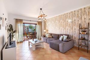 a living room with a couch and a table at Cosy Apartment with Pool 1 in Vilamoura