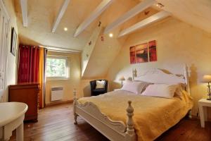 a bedroom with a large bed in a attic at Gites Air Marin in Lannion