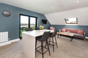 a kitchen and living room with a table and a couch at Ocean Breeze Apt 3 in Dunfanaghy