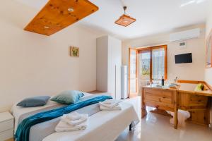 a bedroom with a bed and a wooden desk at Alice's house in Otranto
