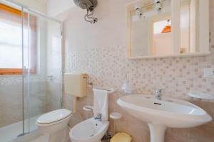 a white bathroom with a sink and a toilet at Alice's house in Otranto +17 photos