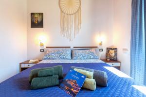a bedroom with a blue bed with two chairs at Hakéyah in Castelsardo