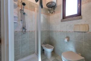 a bathroom with a shower and a toilet and a sink at Hakéyah in Castelsardo +15 photos