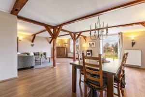 a dining room and living room with a table and chairs at Ferienwohnung Obenauf in Oesterwurth +27 photos
