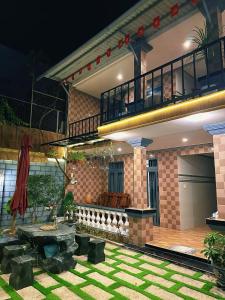 a house with a patio and a table in a yard at Sam's homestay in Ấp Bình Hưng