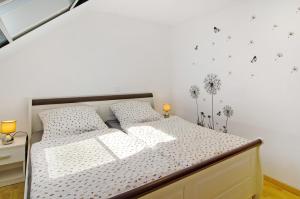 a bedroom with a bed with white walls at Ferienwohnung Otte in Apen
