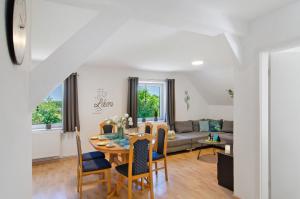 a dining room and living room with a table and chairs at Ferienwohnung Otte in Apen