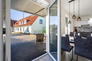 a kitchen and dining room with a view of a house at Ostseerauschen in Hohwacht