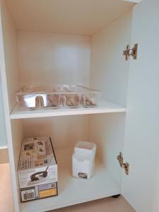 a white cabinet with a box on a shelf at Quinta da Praia in Serra +71 photos