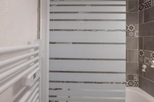a bathroom with a sliding glass shower door at Les chalets du Praz 4 - Immoclean in Morillon +18 photos