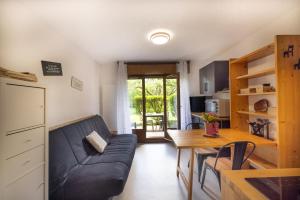 a living room with a couch and a table at Les chalets du Praz 4 - Immoclean in Morillon