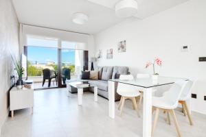 a living room with a table and a couch at Casa Mar y Sol in Los Belones