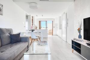 a living room with a couch and a table at Casa Mar y Sol in Los Belones