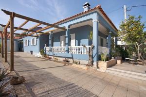 a blue house with a wooden deck at Casa das Buganvilias in Loulé