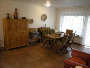 a living room with a dining room table and chairs at Rhön Residence in Dipperz