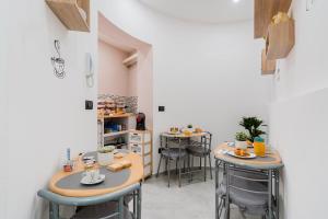 a room with two tables and stools with food on them at Luxury 12 in Tuglie