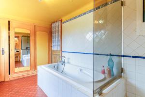 a bathroom with a tub and a glass shower at Van Gogh in Fourques +22 photos