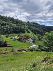 an aerial view of a house in a green field at Aarvik organic farm & bakery in Tveit