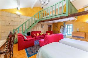 a living room with red furniture and a staircase at Van Gogh in Fourques