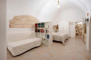 a bedroom with a bed and a book shelf at L' Ippocampo in Polignano a Mare