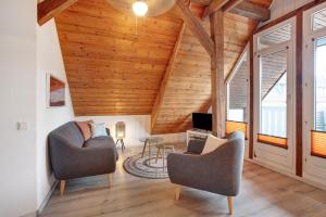 a living room with two chairs and a tv at Ferienwohnung Dashaus in Rheinfelden