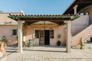 a building with awning and a table and chairs on a patio at Quinta do Passal - Gondoriz in Gondoriz