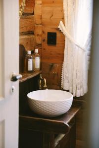 a bathroom with a white bowl sink on a counter at Aarvik organic farm & bakery in Tveit