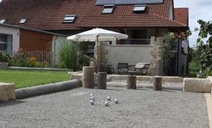 a group of balls on the ground in front of a house at Weingut Landerer in Vogtsburg