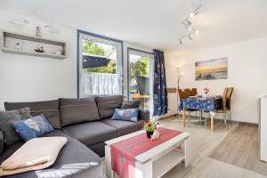 a living room with a couch and a table at Bungalow Mary Ann, Bgl 25 in Dranske