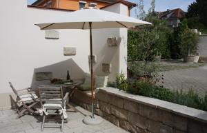 a patio with an umbrella and a table and chairs at Weingut Landerer in Vogtsburg +88 photos