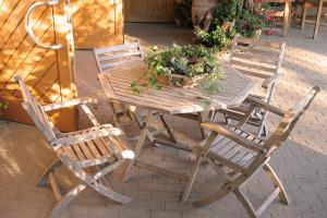 a wooden table and chairs with plants on it at Weingut Landerer in Vogtsburg