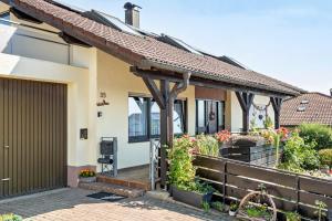 a house with a porch and a fence at Gästehaus Gaby in Bad Bellingen