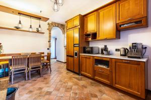 a kitchen with wooden cabinets and a dining room at L'antica Lugana front lake in Sirmione
