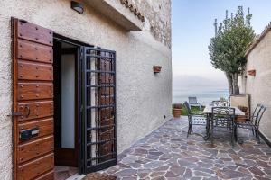 an open door to a patio with a table at L'antica Lugana front lake in Sirmione
