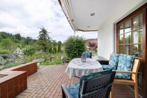 a patio with a table and chairs on a patio at Ferienwohnung am Steinbach in Albstadt