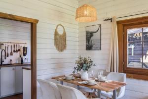 a dining room with a wooden table and chairs at Almhütte in Ulrichstein