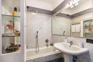 a bathroom with a sink and a bath tub and a sink at L'antica Lugana front lake in Sirmione +22 photos