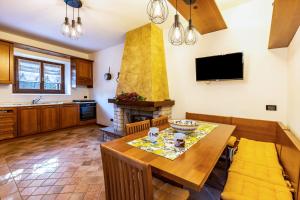 a kitchen with a dining table and a fireplace at L'antica Lugana front lake in Sirmione