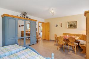 a bedroom with a bed and a table and chairs at Ferienwohnung am Steinbach in Albstadt +21 photos