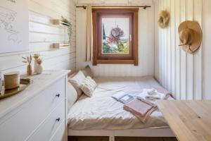 a small bed in a small room with a window at Almhütte in Ulrichstein +24 photos