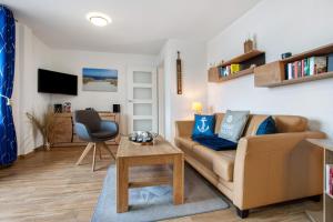 a living room with a couch and a table at Ferienwohnung Abendrot 299 in Ueckermünde