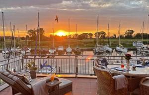 a balcony with a table and chairs and a marina at Ferienwohnung Abendrot 299 in Ueckermünde