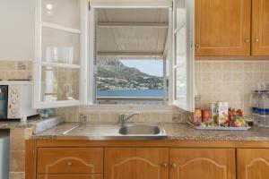 a kitchen with a sink and a window at Studio Telendos in Telendos