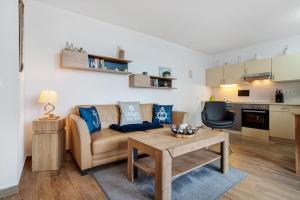 a living room with a couch and a table at Ferienwohnung Abendrot 299 in Ueckermünde