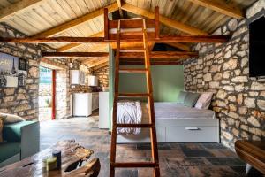 a bedroom with a bunk bed in a stone wall at Villa Nikos in Kefallonia