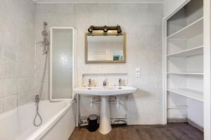 a bathroom with a sink and a mirror and a tub at Le Gîte du Château Saint Ahon in Blanquefort +20 photos